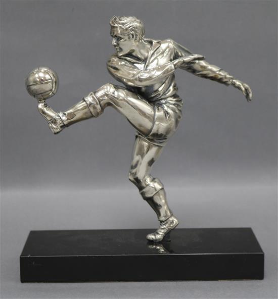 A plated metal footballer on marble base height 19cm